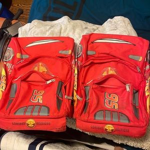 Two lightning McQueen backpack/rolling suitcase